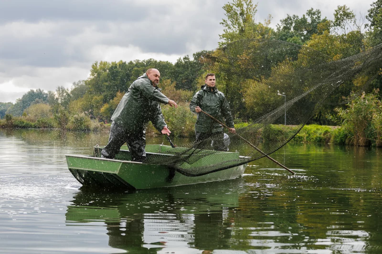 Harvest at the Antonius sturgeon farm, with nets cast from a boat on open water